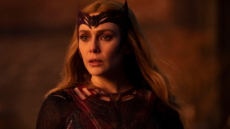 Elizabeth Olsen as Scarlet Witch/Wanda Maximoff wearing her tiara and bathed in warm light in Doctor Strange in the Multiverse of Madness