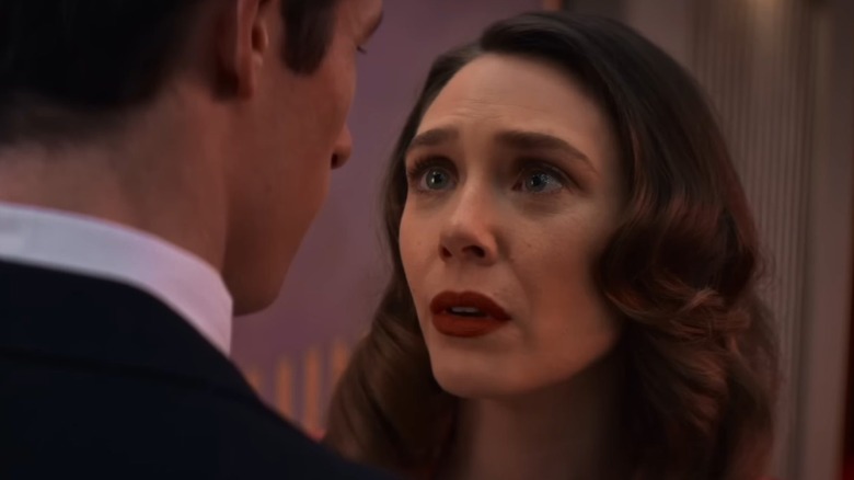 Elizabeth Olsen as Joan looking tearfully at Callum Turner as Luke in Eternity