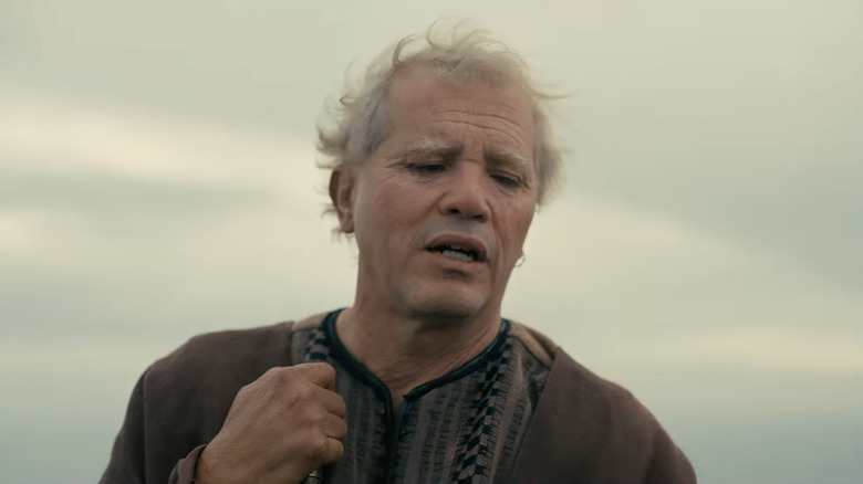 Eumaeus standing under a cloudy sky in The Odyssey (2026)