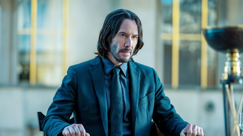 John Wick 4, John Wick sitting down talking to the high table