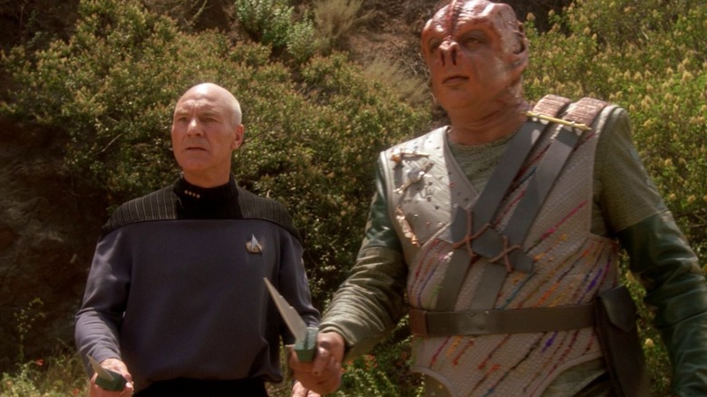 Captain Picard and Dathon looking at something in the wilderness on Star Trek: The Next Generation