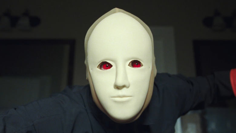 Arthur wearing red contacts and a mask in Faces of Death