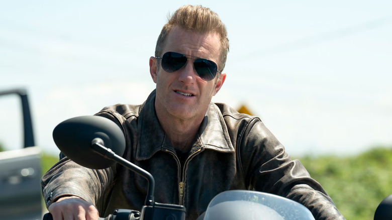 Scott Caan as Jason Grant sitting on his motorcycle in Alert: Missing Persons Unit