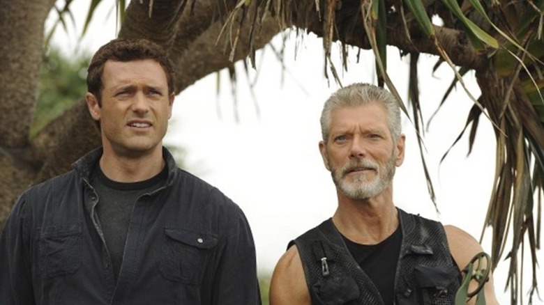 Jim and Taylor look at the distance with concern in Terra Nova