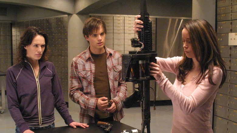 Cameron loading a grenade launcher with John and Sarah Connor in The Sarah Connor Chronicles