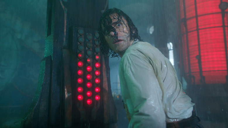 Oscar Issac as Victor Frankenstein soaking wet in his lab in Frankenstein (2025)