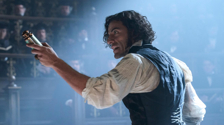 Victor Frankenstein holding a battery in 2025's Frankenstein