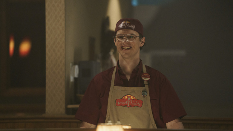 Freddie Stroma as Adrian/Vigilante on Peacemaker season 1 in his Fennel Fields uniform looking excited