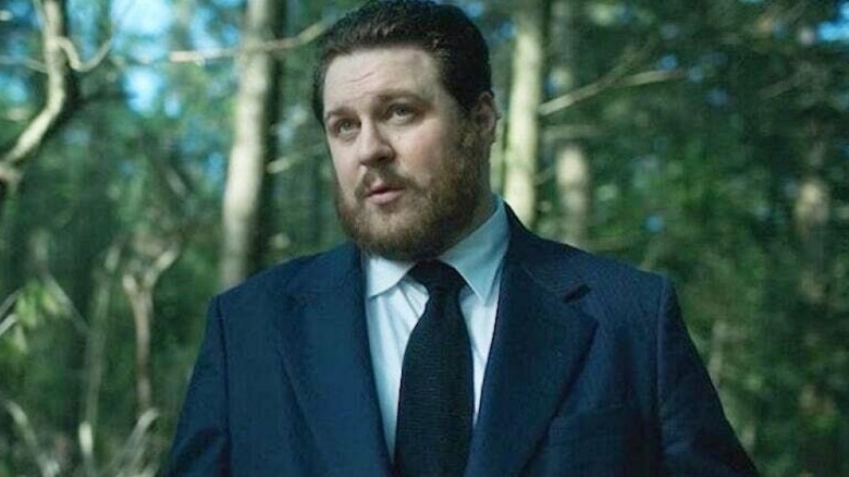Hazel (Cameron Britton) standing in a forest on "The Umbrella Academy"