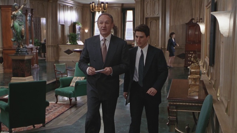 Avery Tolar and Mitch McDeere walking through a fancy law office in "The Firm."