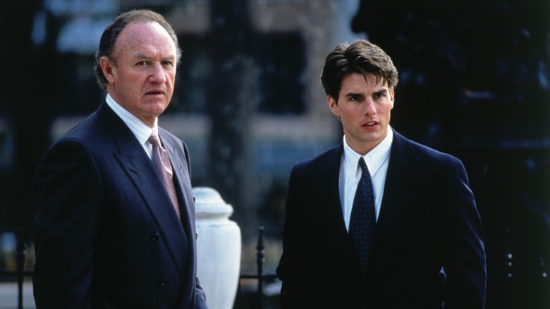 Avery Tolar and Mitch McDeere looking nervously at something in "The Firm."