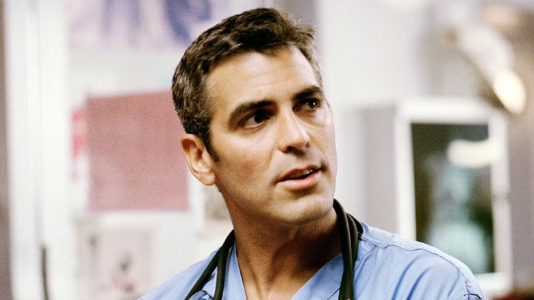 Doug Ross with short hair in scrubs looking off to the side in ER