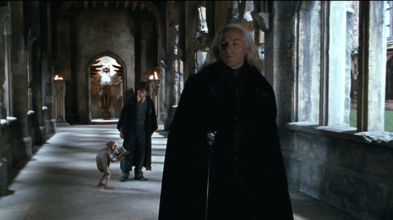 Dobby opening the diary next to Harry as Lucius begins to turn around in Harry Potter and the Chamber of Secrets