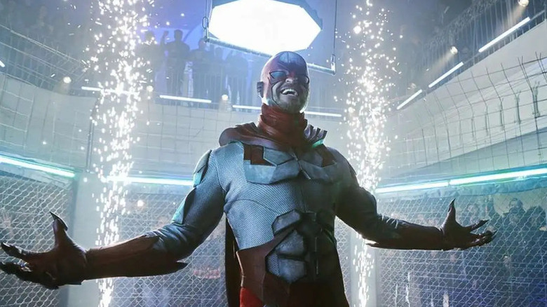 Alan Ritchson as Hawk posing in a cage on Titans