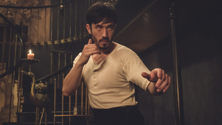 Ah Sahm squares off in a white t-shirt and prepares to fight his opponent in 