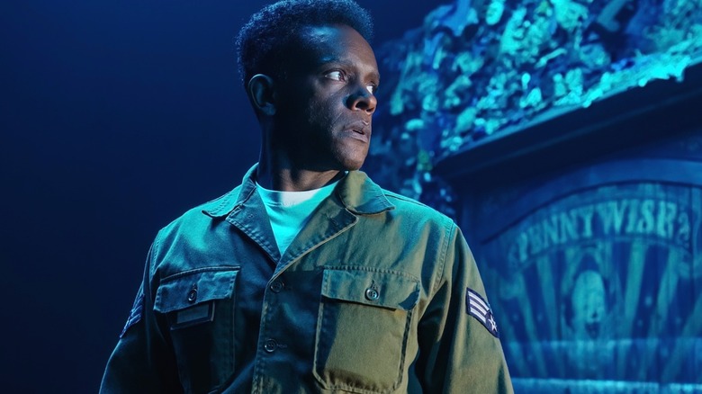 Dick Halloran, played by Chris Chalk, gives a surprised sideways glance in the film 