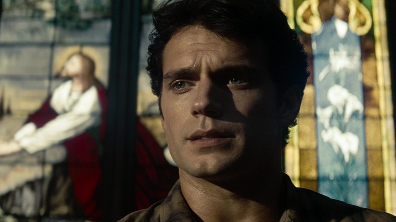 Henry Cavill's Superman is seen sitting in a church in closeup in Man of Steel