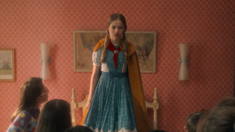 Holly Wheeler standing on a bed in "Stranger Things"