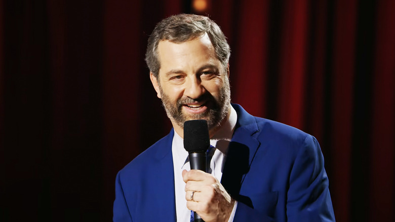 Judd Apatow holds a microphone while performing stand=up comedy in Judd Apatow The Return