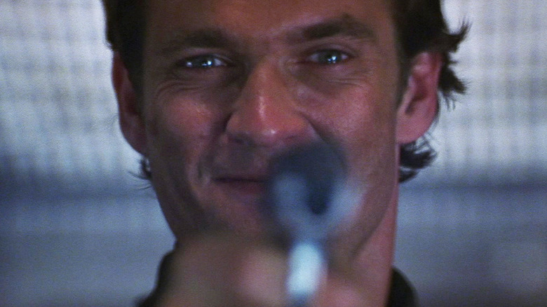 Dougray Scott as Sean Ambrose pointing his gun at the camera in Mission: Impossible II