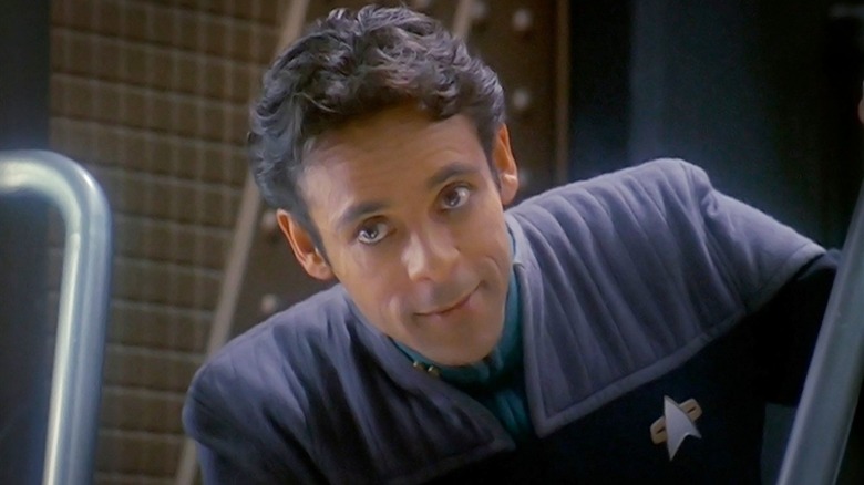 Dr. Bashir leaning over on Star Trek: Deep Space Nine