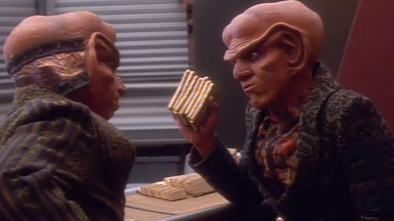 Quark holding a pile of gold-pressed latinum on Star Trek