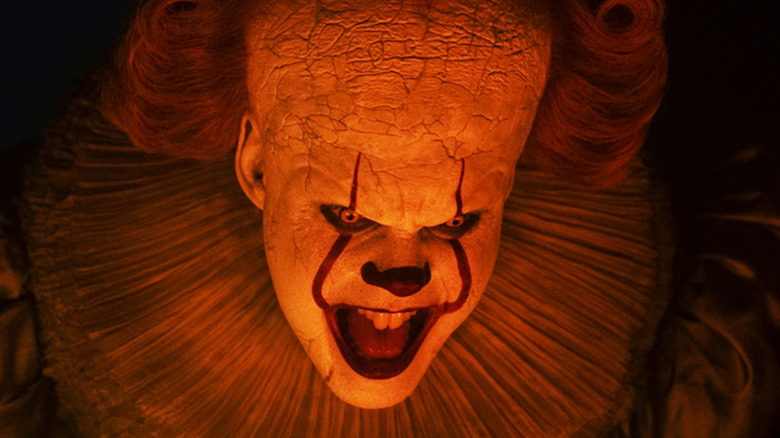 Bill Skarsgård's Pennywise opens his mouth in closeup in It Welcome to Derry