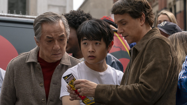 Mr. Han (Jackie Chan), Li Fong (Ben Wang), and Daniel LaRusso (Ralph Macchio) stand together in 