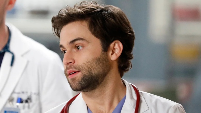 Levi with a beard and a stethoscope looking to the side on Grey's Anatomy