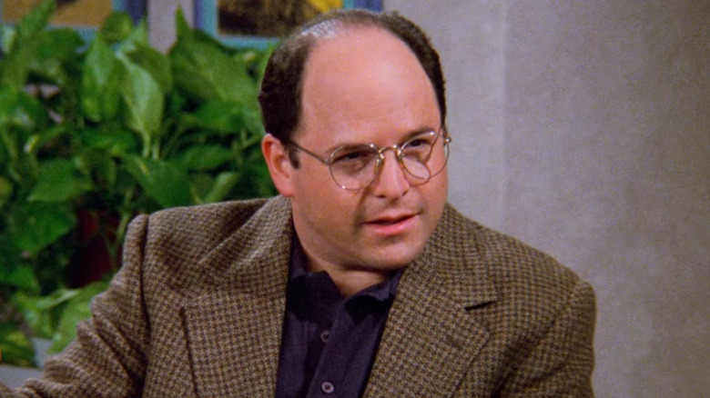 George sitting in a diner on Seinfeld