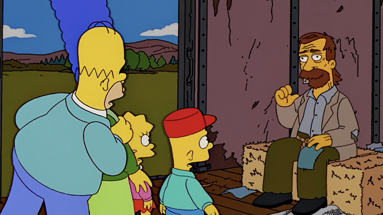 The Simpsons family stand on a train looking at a hobo sitting on hay in The Simpsons