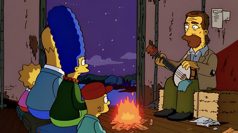 The Simpsons family sit in front of a campire opposite a hobo on a train in The Simpsons
