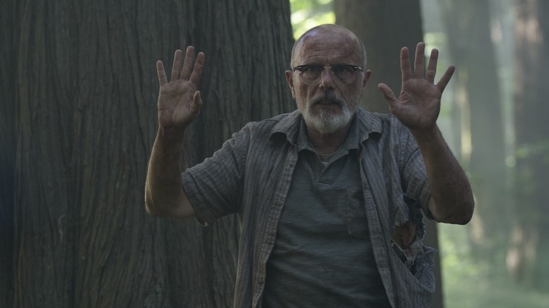 Eugene holding his hands up in surrender on The Last of Us