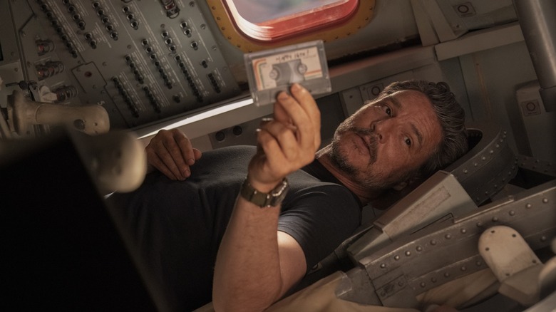 Joel holds a cassette strip that places horizontally at the end