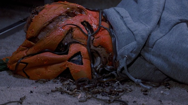 A dead kid with bugs and snakes in place of his head in Halloween III: Season of the Witch