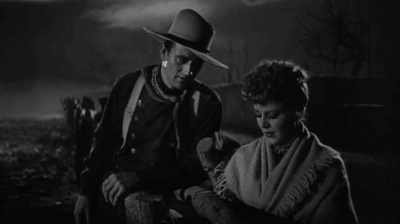 John Wayne Como Henry, el niño de Ringo está al lado de Claire Trevor como Dallas en Stagecoach