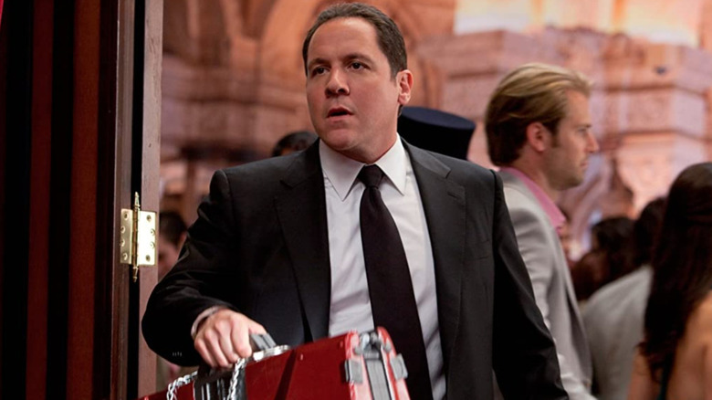 Happy Hogan holding a briefcase of Tony Stark's armor in Iron Man 2
