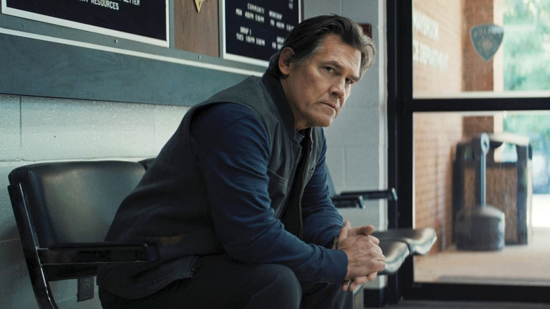 Josh Brolin as Archer looks anxious as he sits in Weapons