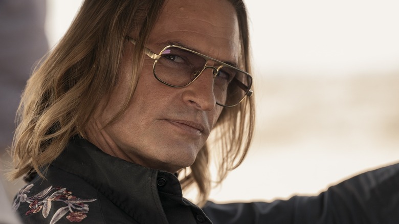 Josh Holloway as driver Jim Ellis sporting sunglasses at the wheel of his car in Duster