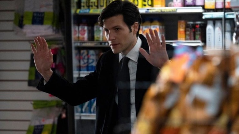 Avraham with his hands up in a convenience store in The Calling