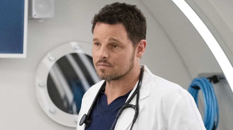 Alex Karev (Justin Chambers) looking skeptical in a white coat with a stethoscope on Grey's Anatomy