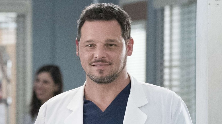 Alex Karev (Justin Chambers) smiling in his white coat on Grey's Anatomy