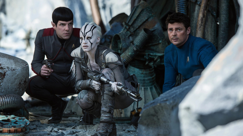Spock and Bones crouched with Jaylah in Star Trek Beyond