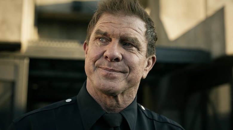 Kenny Johnson as Luca looking to his right in his uniform holding back tears in S.W.A.T.