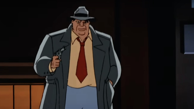 Harvey Bullock stands in shadows holding a gun in Batman: The Animated Series