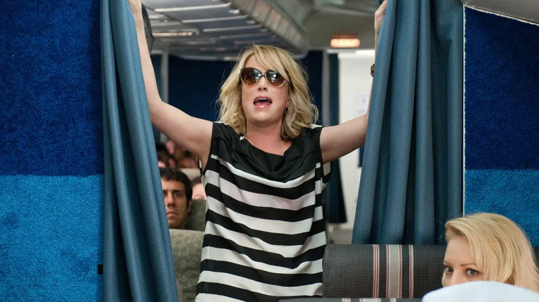 Annie pulling the first class curtains open and yelling in Bridesmaids