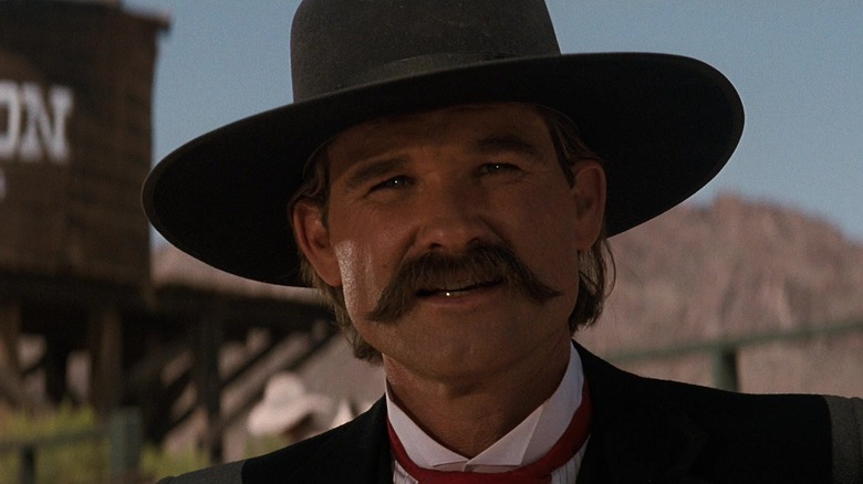 Kurt Russell as Wyatt Earp wearing a cowboy hat in Tombstone