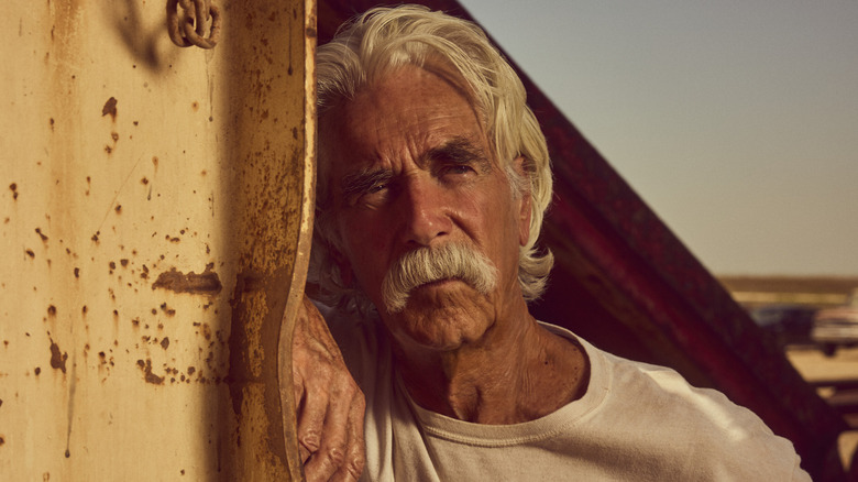 Sam Elliott's T.L. Norris leans against a girder in Landman.jpg