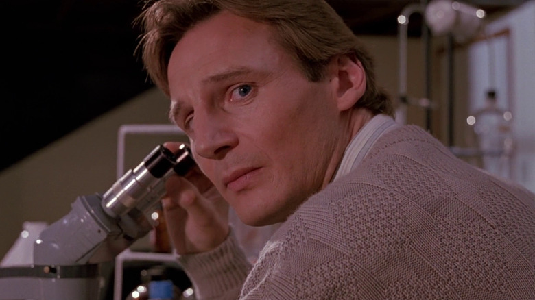 Dr. Peyton Westlake looking away from a micoscope in Darkman