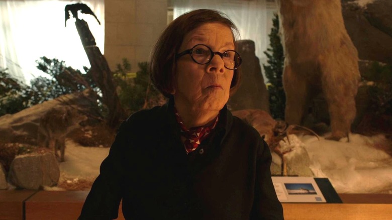Linda Hunt as Hetty standing in front of stuffed dead animals in the NCIS: Los Angels episode Mother